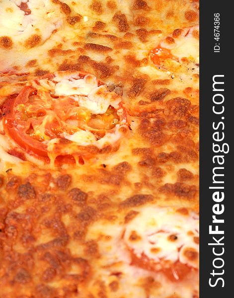 Close up of a cheese & Tomato pizza with large tomato slice in the middle. Close up of a cheese & Tomato pizza with large tomato slice in the middle