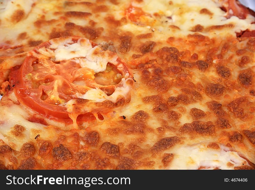Rectangle image, Close up of a cheese & Tomato pizza with large tomato slice in the middle. Rectangle image, Close up of a cheese & Tomato pizza with large tomato slice in the middle