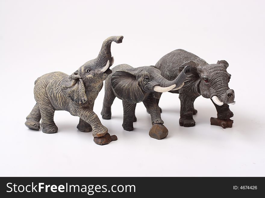 Three ceramic elephant figurines isolated over white background
