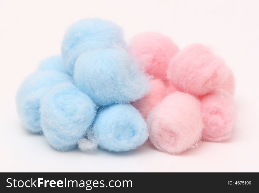 Blue and pink hygienic cotton balls isolated on a white background