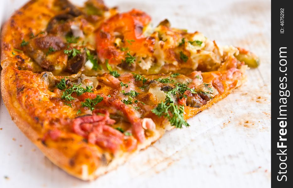 Piece of the Italian pizza on a cardboard. Piece of the Italian pizza on a cardboard