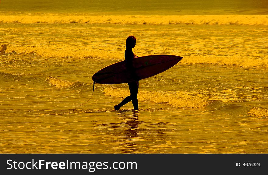 Female Surfer going into the water. Female Surfer going into the water