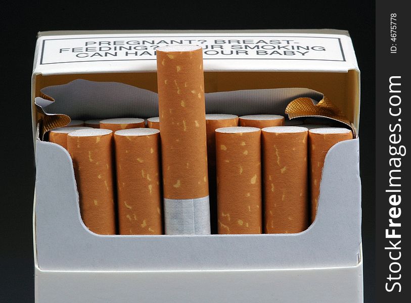A packet of cigarettes with one extended, as if offered to a smoker.  A warning against smoking and breastfeeding is visible at the top of the packet. A packet of cigarettes with one extended, as if offered to a smoker.  A warning against smoking and breastfeeding is visible at the top of the packet.