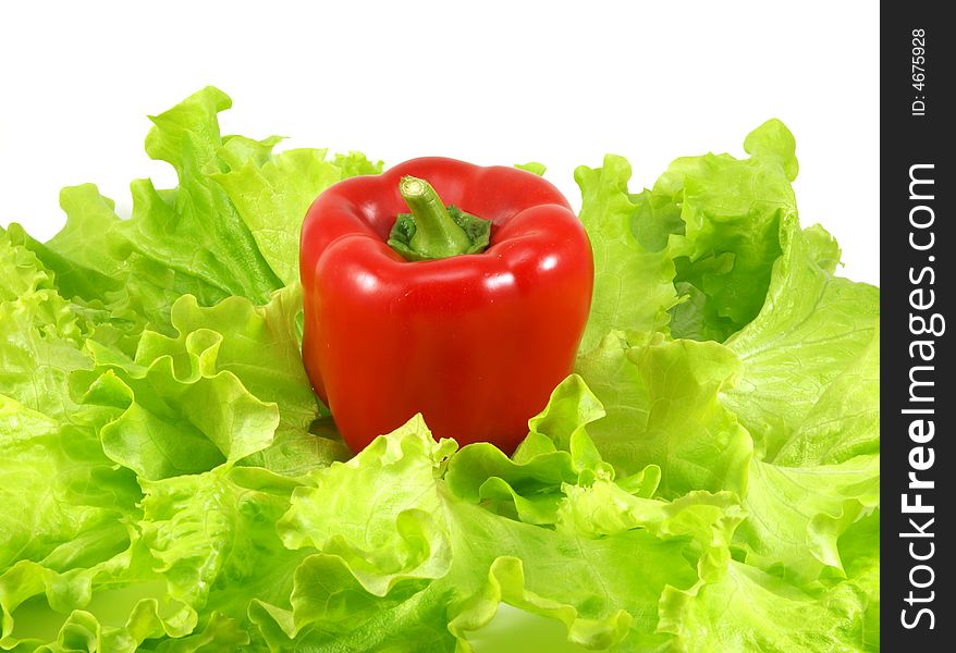 Red pepper and leaves of salad isolated on a white background