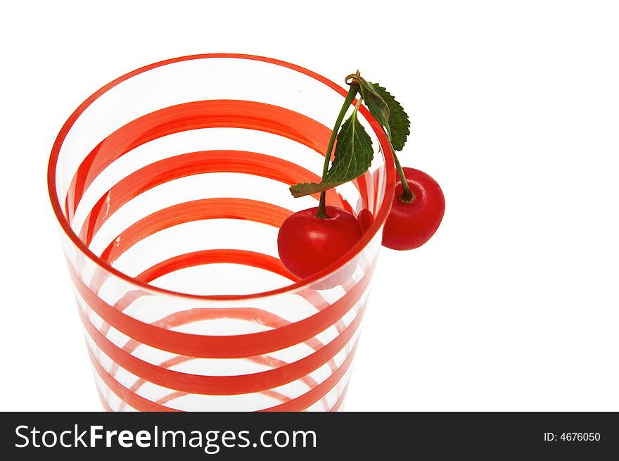 Glass with two cherries on a white background