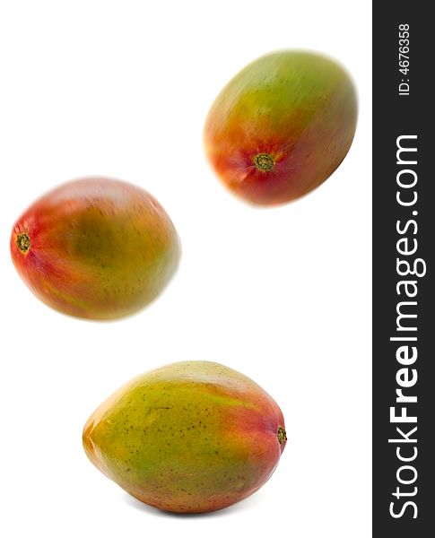 Falling mango group isolated over white. motion blur. Falling mango group isolated over white. motion blur