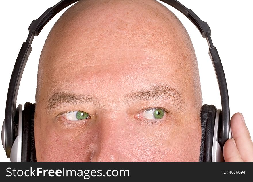 Male listening to music on full ear headphones. Male listening to music on full ear headphones