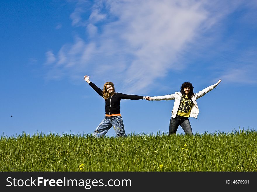 Two arms raised friends in a green meadow