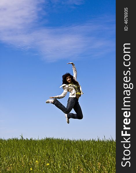 Happy jumping woman, vertical composition.