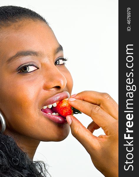 Sweet african girl eating a juicy strawberry. Sweet african girl eating a juicy strawberry