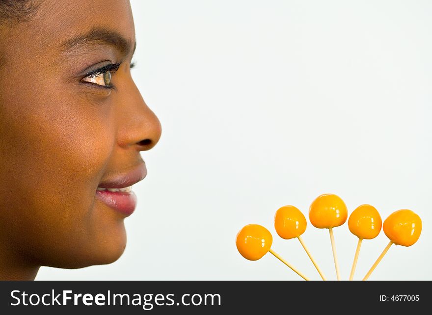 Nice-looking african girl with a bunch of yellow tropical fruits. Nice-looking african girl with a bunch of yellow tropical fruits