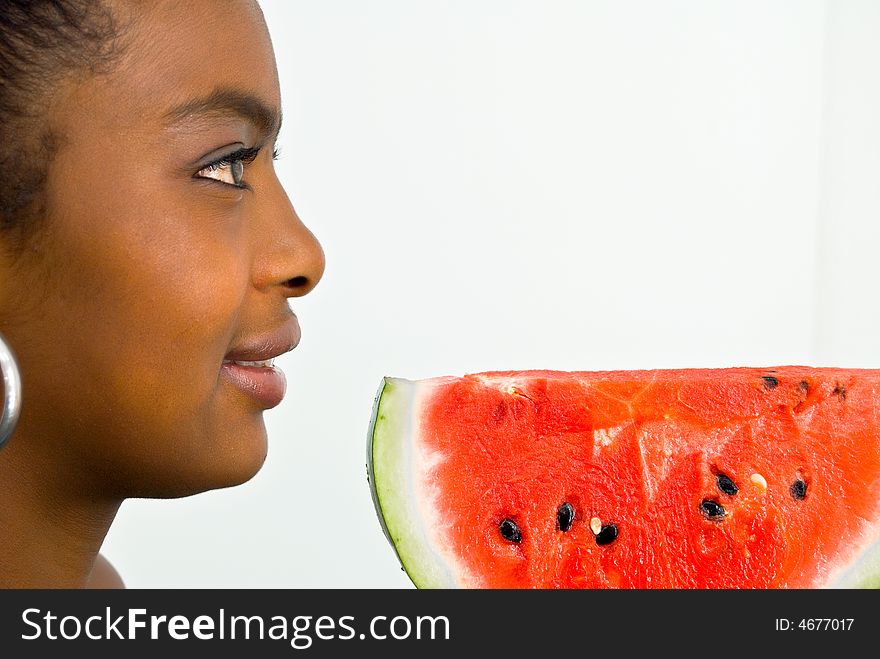 Sweet smiling girl with a red juicy wate-melon