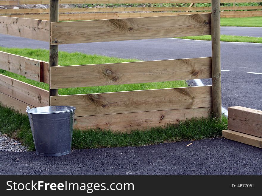 A fence with a bucket at the end. A fence with a bucket at the end