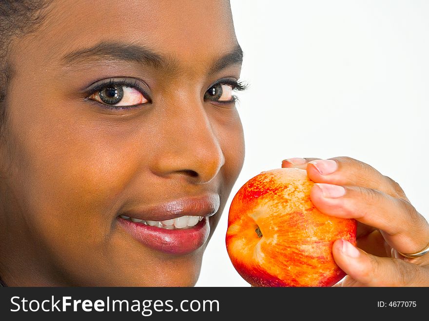 Close-up portrait of beautiful african girl with a peach