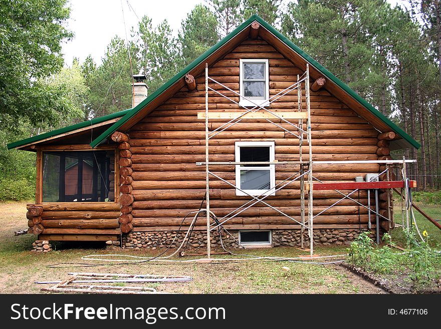 Scaffolding set up outside of a log home. Scaffolding set up outside of a log home