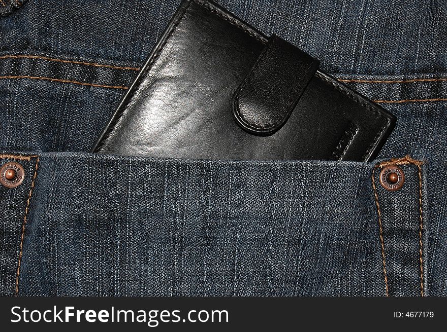 Black wallet in the pocket of jeans