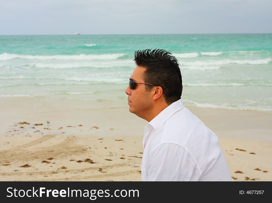 Man alone sitting on the beach. Man alone sitting on the beach.