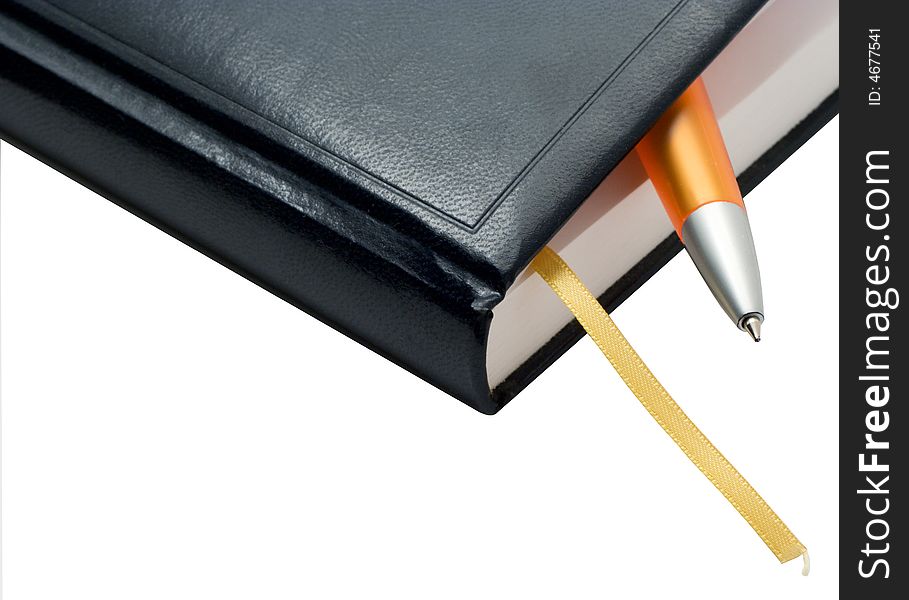 The note book with a pen on a white background. Photo.