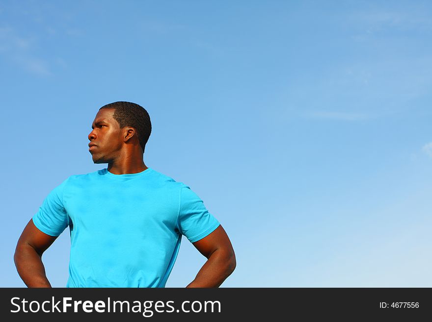 Upper body shot of a man standing against a blue sky background. Plenty of copyspace here. Upper body shot of a man standing against a blue sky background. Plenty of copyspace here.