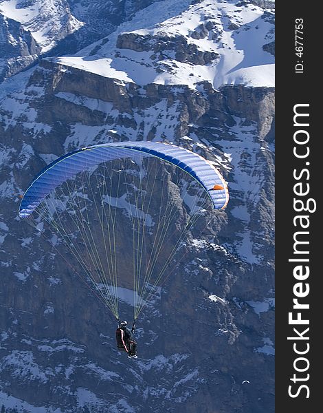Paraglider hovering along the cliffs