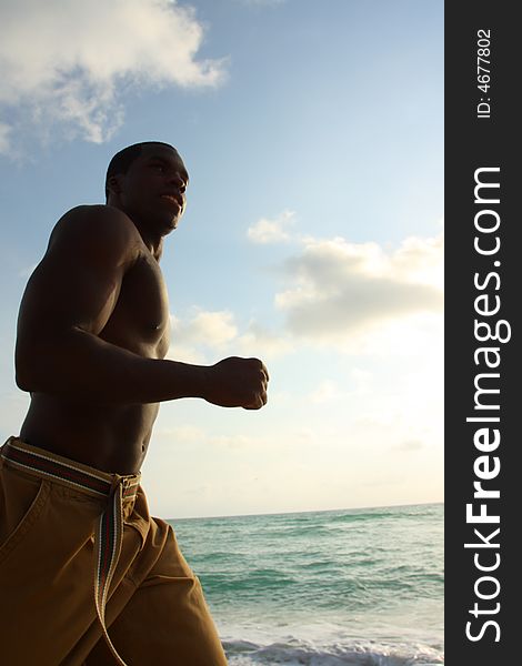 Silhouette Of A Man Running On The Beach