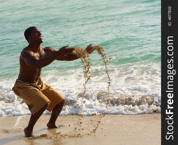 Man playing on the beach with sand. Man playing on the beach with sand.