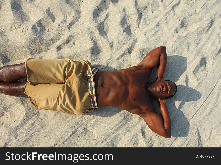 Man laying on the beach sand. Man laying on the beach sand