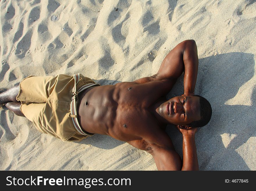 Man laying on the beach sand. Man laying on the beach sand