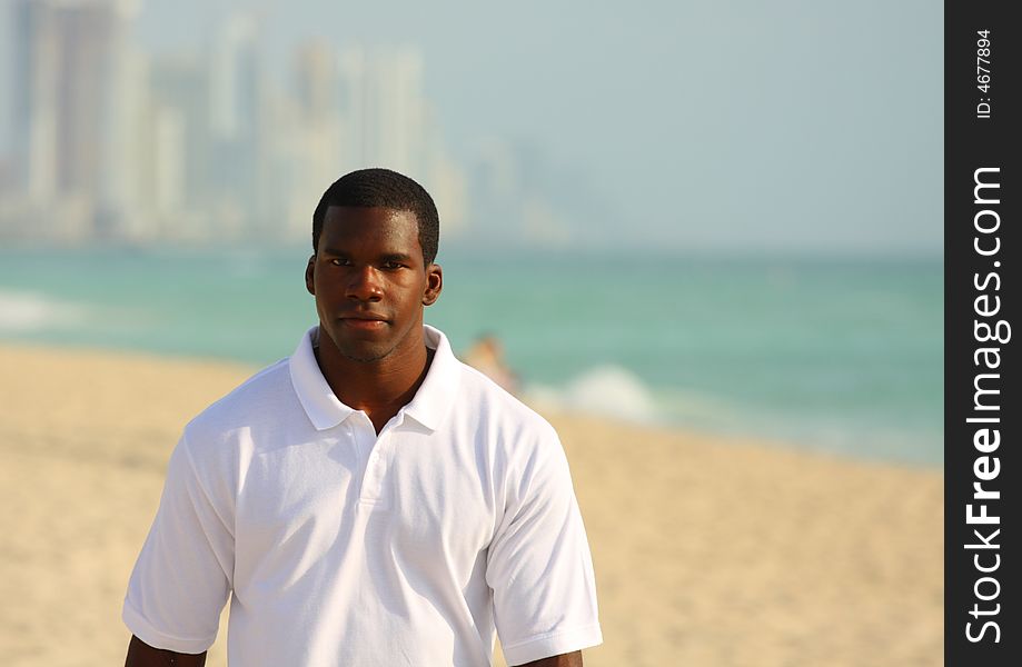 Man walking on the beach looking ahead. Man walking on the beach looking ahead