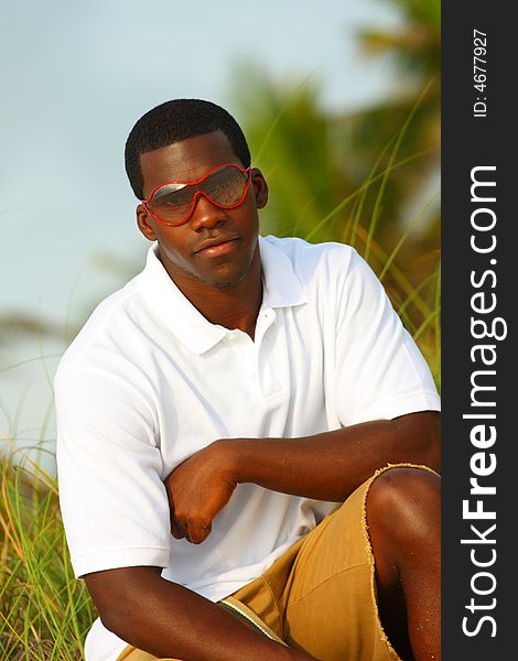 Stylish young black man with red sunglasses. Stylish young black man with red sunglasses
