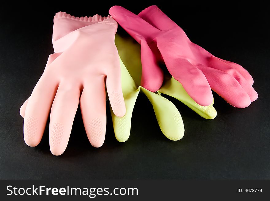 Kitchen gloves of various colors on dark background