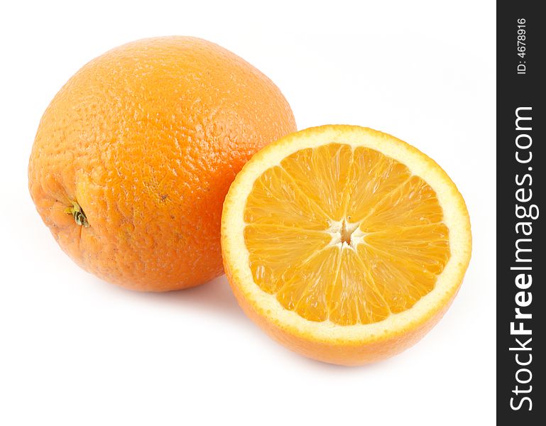 Big oranges isolated on white background one of which is cut