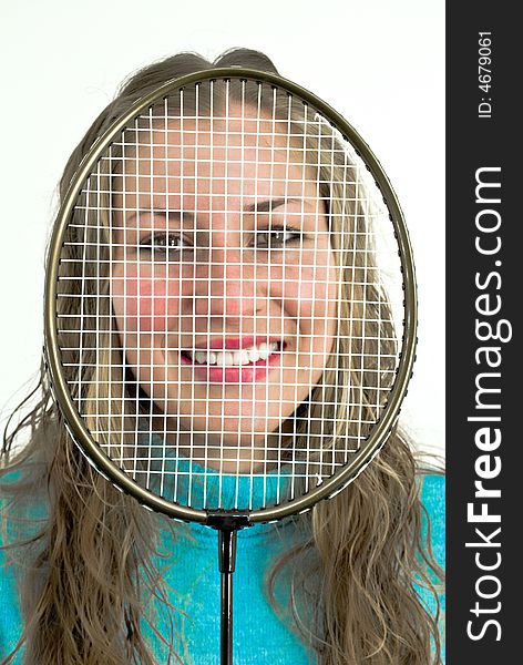 Young lady smiling behind a racket. Young lady smiling behind a racket