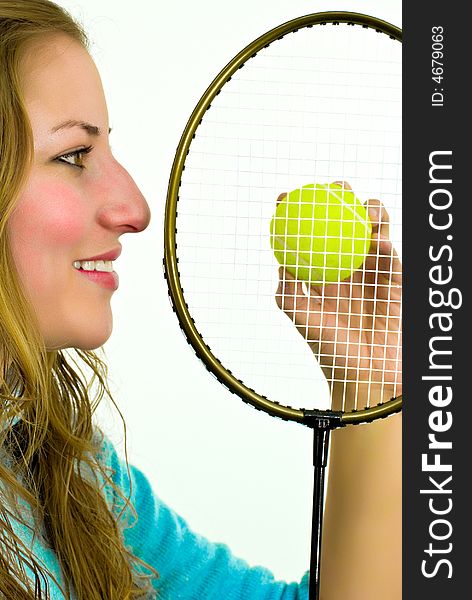 Smiling young woman with racket and yellow ball
