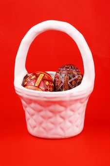 Two Easter Eggs In White Basket Over Red Stock Image Two Easter Eggs In White Basket Over Red Stock Image