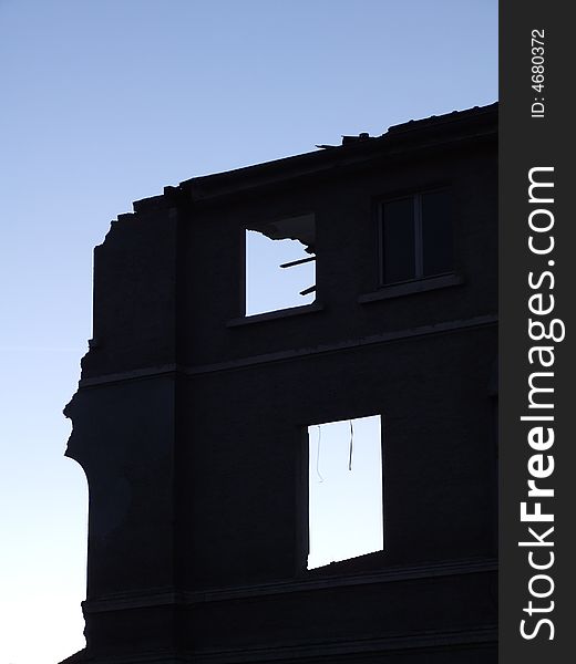 Single wall of a demolished house at dawn. Single wall of a demolished house at dawn