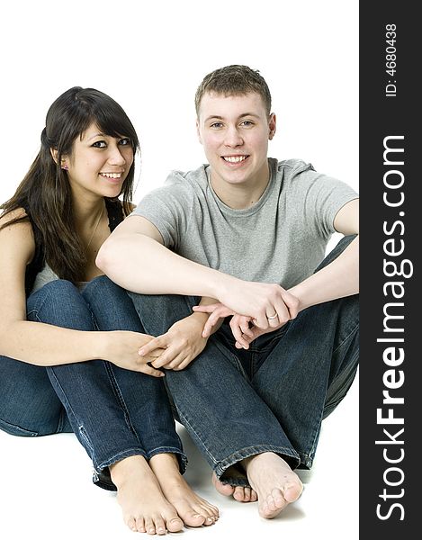 A young couple sitting with each other in a studio. A young couple sitting with each other in a studio