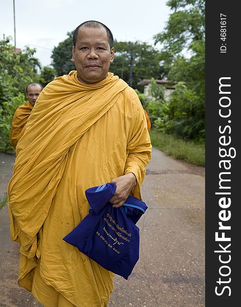 Buddhist monk from Thailand in traditional orange garb