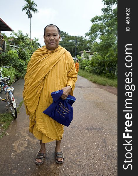 Buddhist monk from Thailand in traditional orange garb