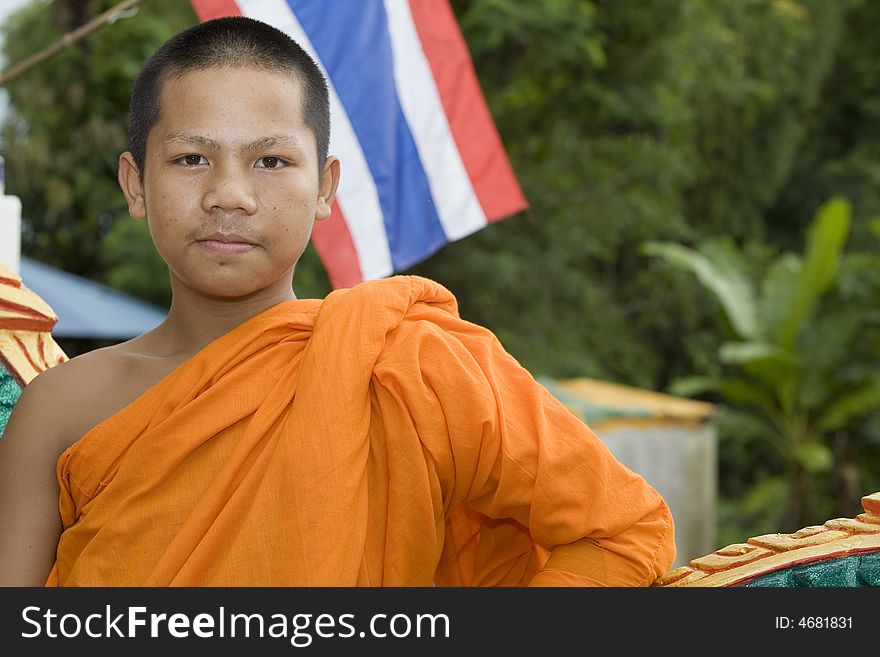 Buddhist monk from Thailand in traditional orange garb