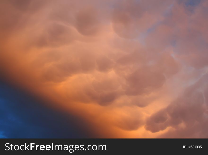 Rain cloud on late afternoon sky on sunset