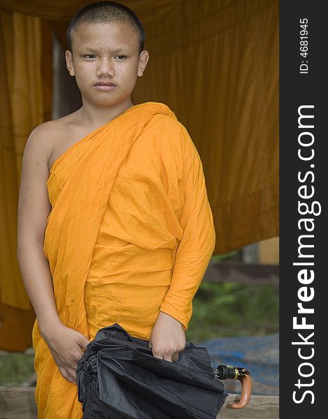 Buddhist monk from Thailand in traditional orange garb