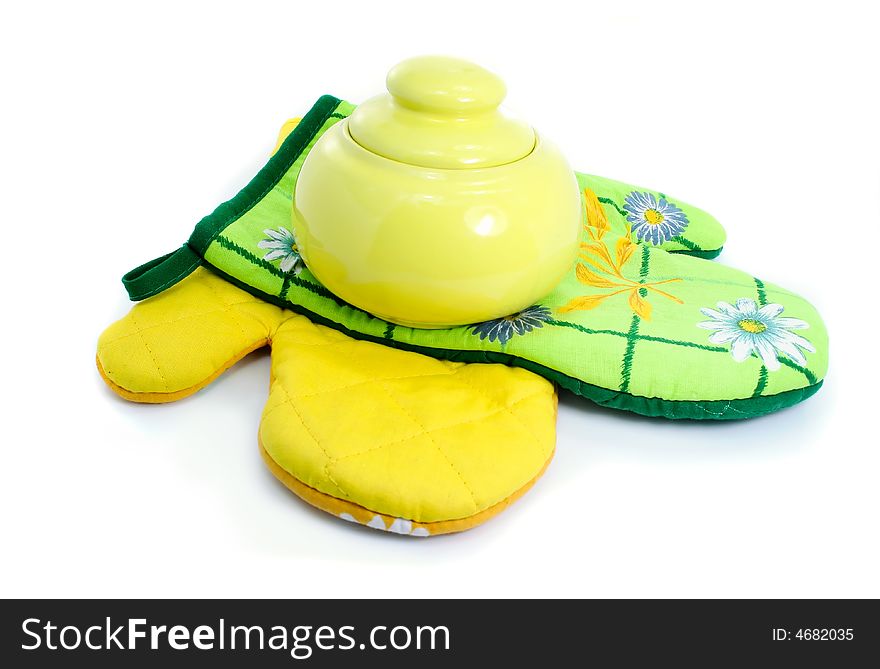 Clay pot on kitchen mittens isolated over white background