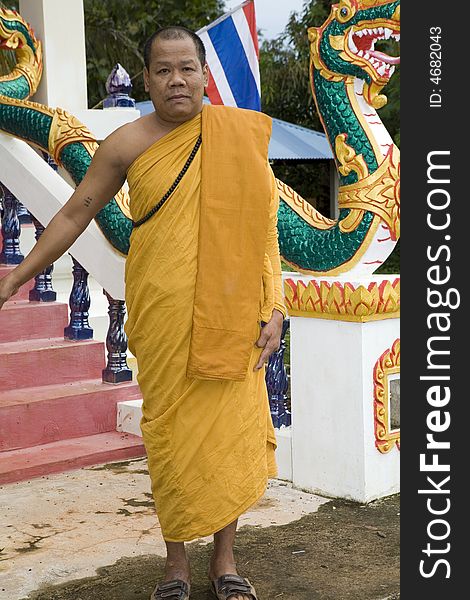 Buddhist monk from Thailand in traditional orange garb