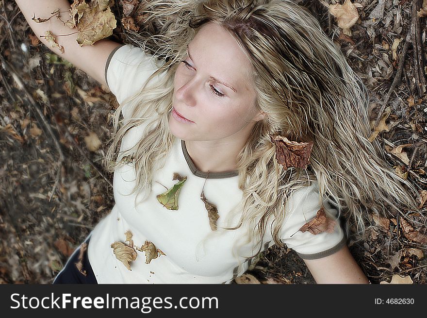 Girl laying in fallen leaves. Girl laying in fallen leaves