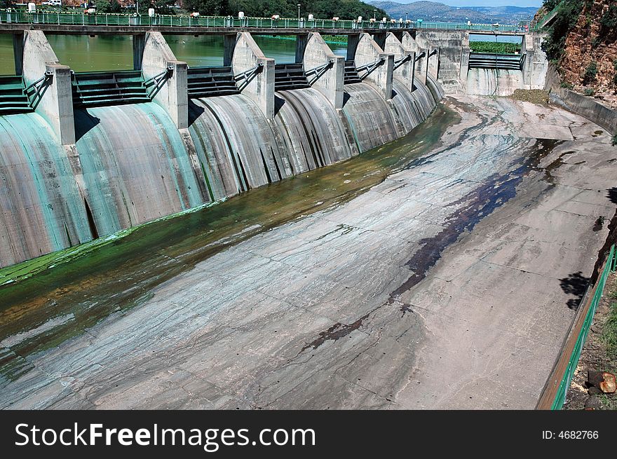 A large concrete dam wall, photographed in South Africa.