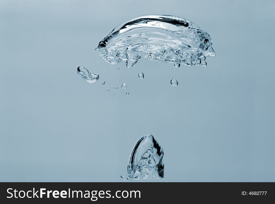 Air-bubbles rising in the water, isolated over blue. Air-bubbles rising in the water, isolated over blue