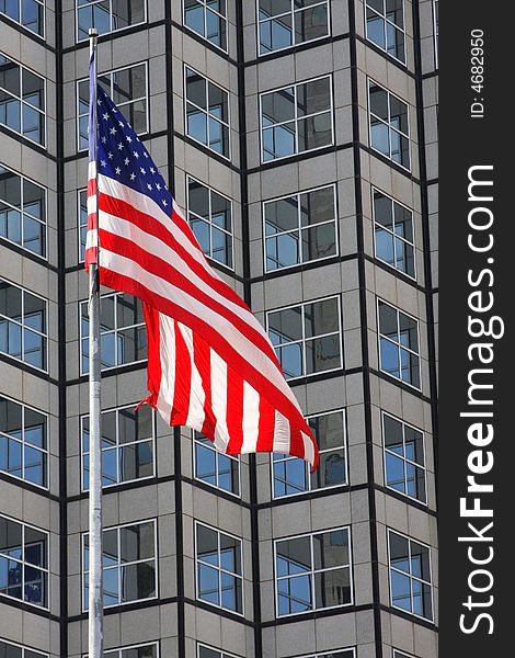 American Flag waving in front of financial building in downtoen Miami.