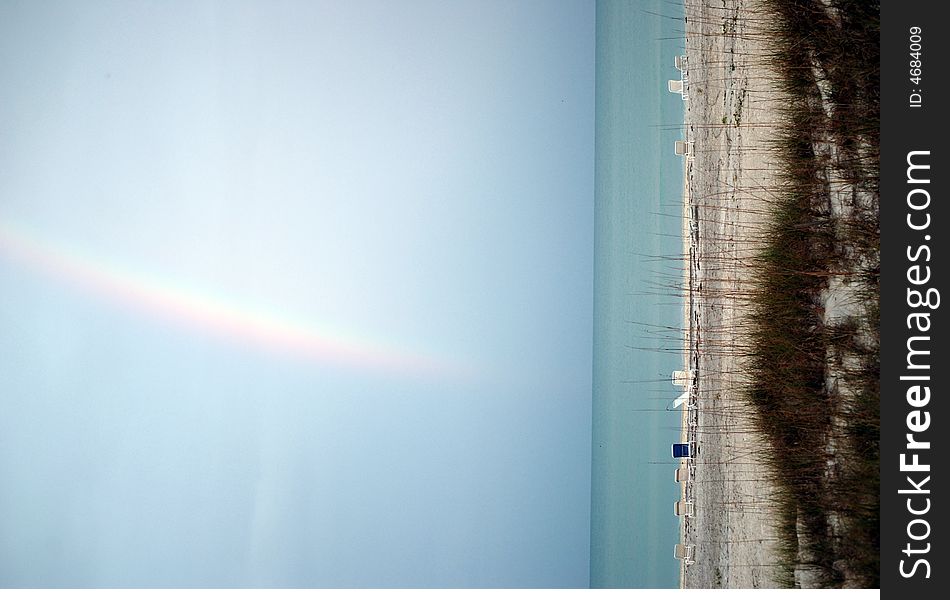 An early morning rainbow over the ocean as seen from a Florida beach. An early morning rainbow over the ocean as seen from a Florida beach.