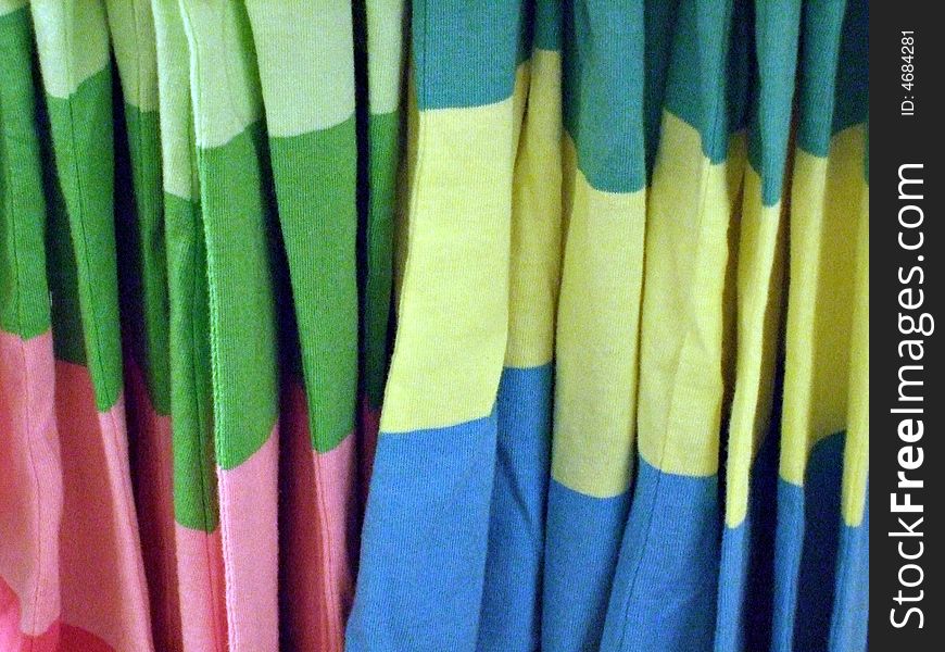 A row of shirts hanging in a clothing store. A row of shirts hanging in a clothing store.